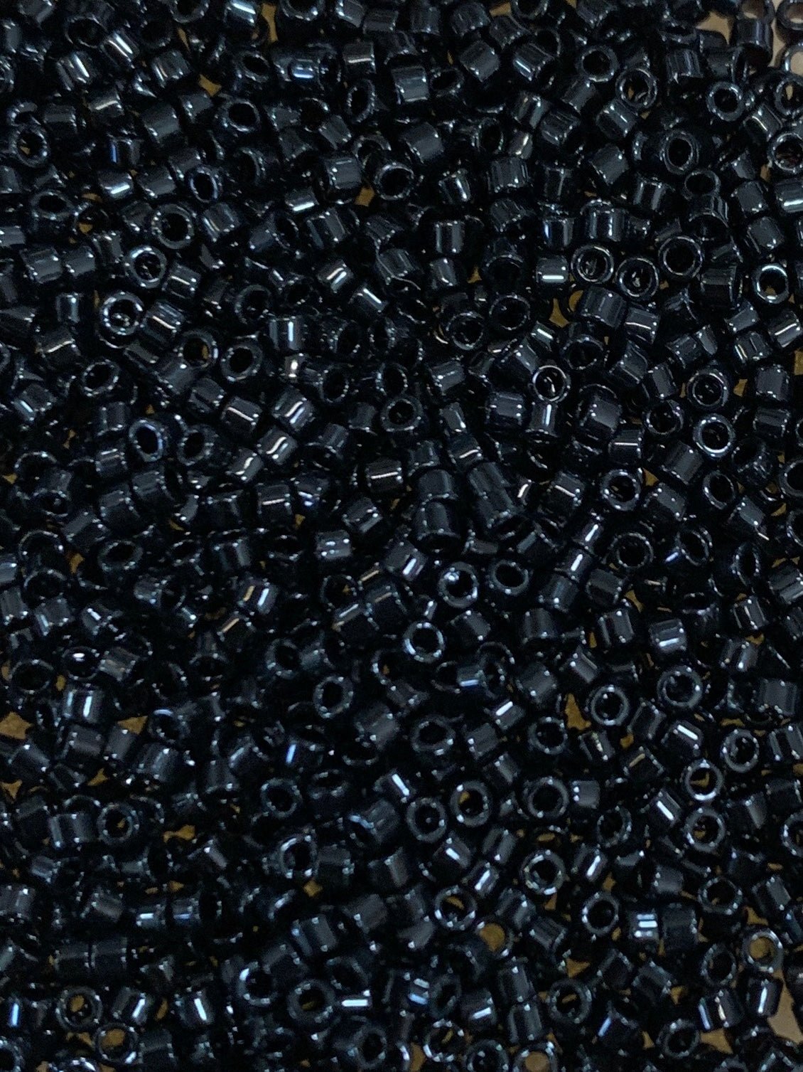 Delica beads size 11 in black.